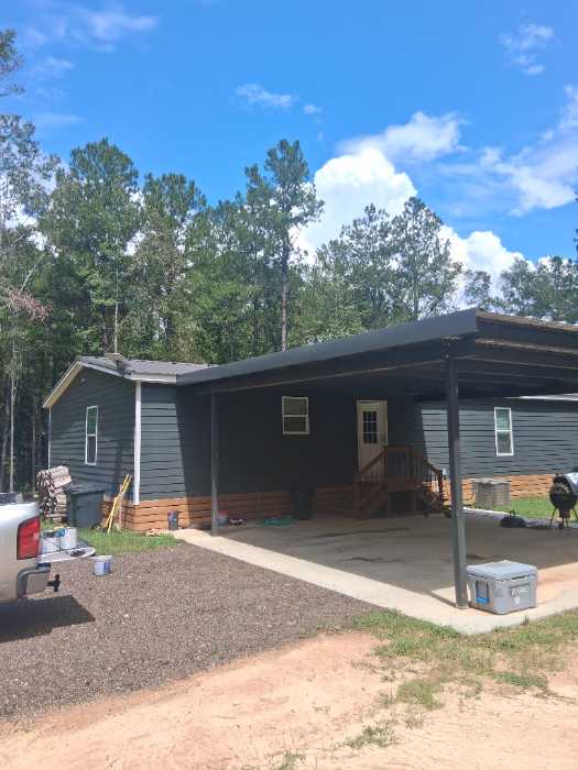 Painting custom color trim to match metal roof install in Florence, MS