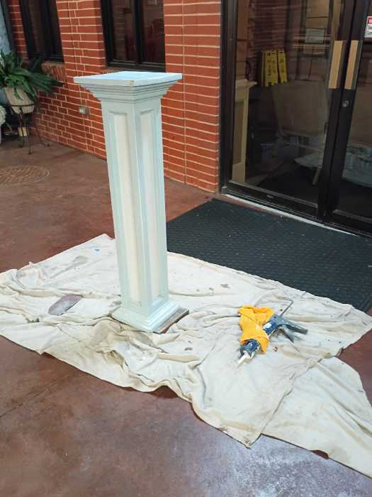 Caulking and painting a wooden podium in Richland, MS