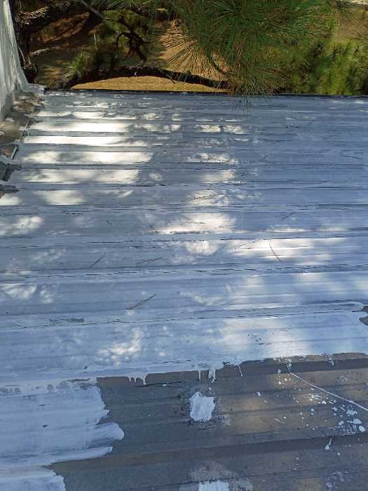Priming rust spots on metal roof to get ready for silicone in Madison, MS, photo 3
