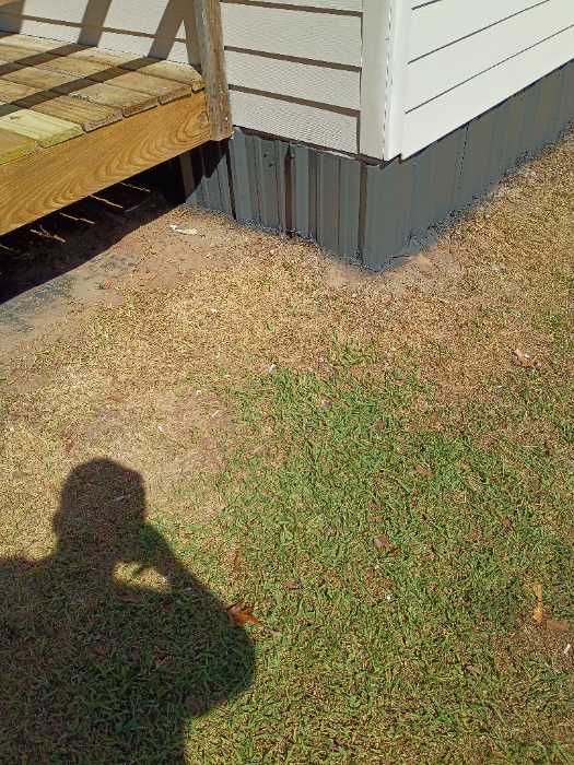 Painting the metal around the bottom of the house with DTM paint in Brandon, MS