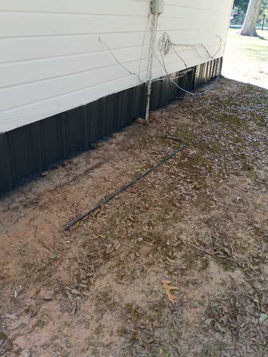 Painting the metal around the bottom of the house with DTM paint in Brandon, MS, photo 3