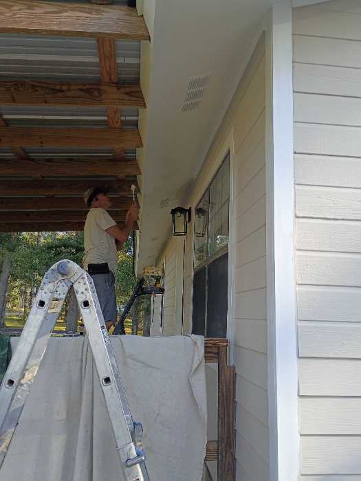Painting trim around the house in Brandon, MS