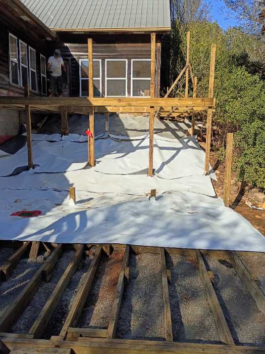 Laying out TPO under a wooden deck so he can be watertight in Raymond, MS, photo 3
