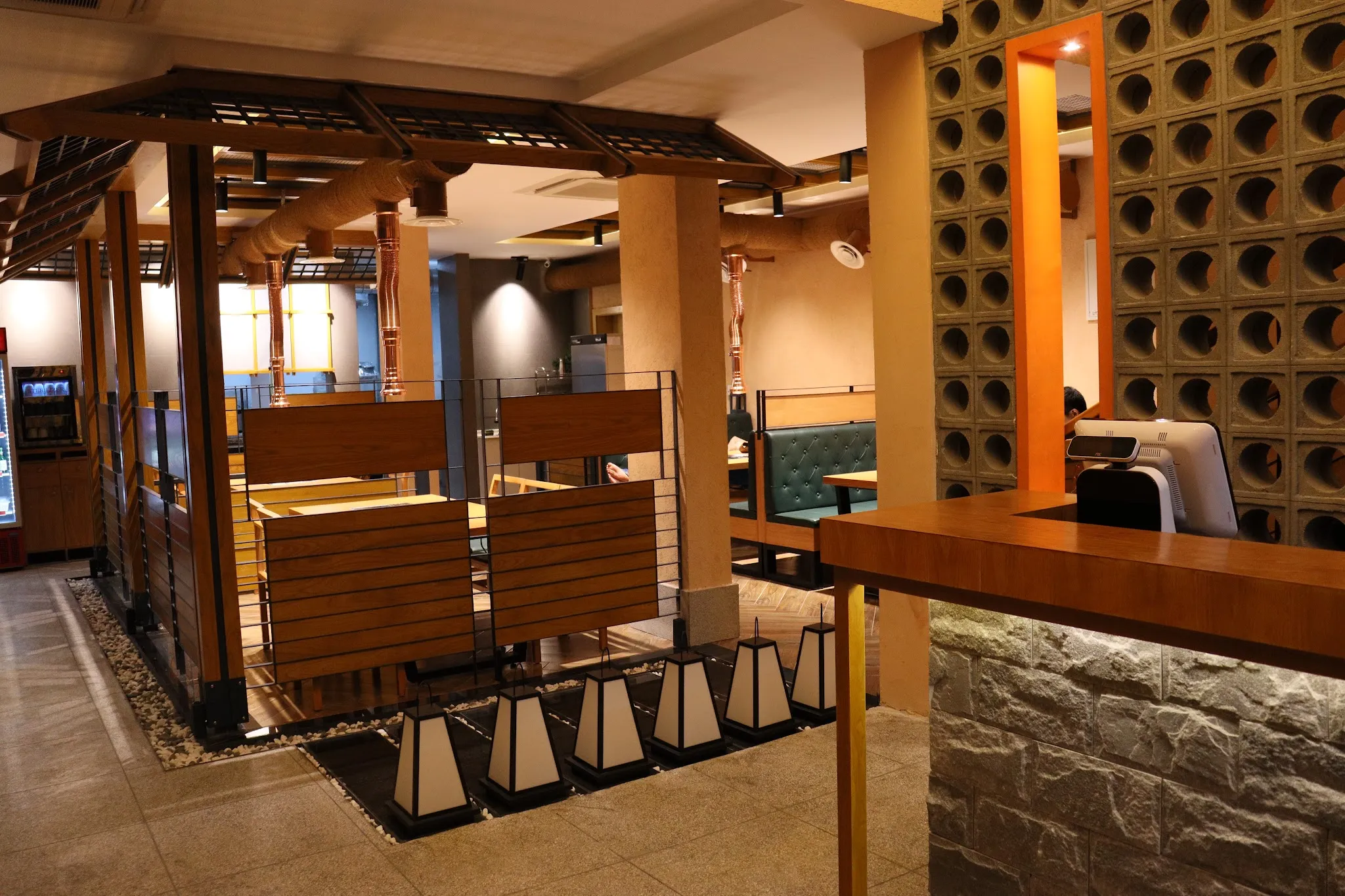 Charcoal tabletop grills at DOSEGI Korean BBQ on Street 302, Boeung Keng Kang, where six complimentary banchan arrive with every table for two