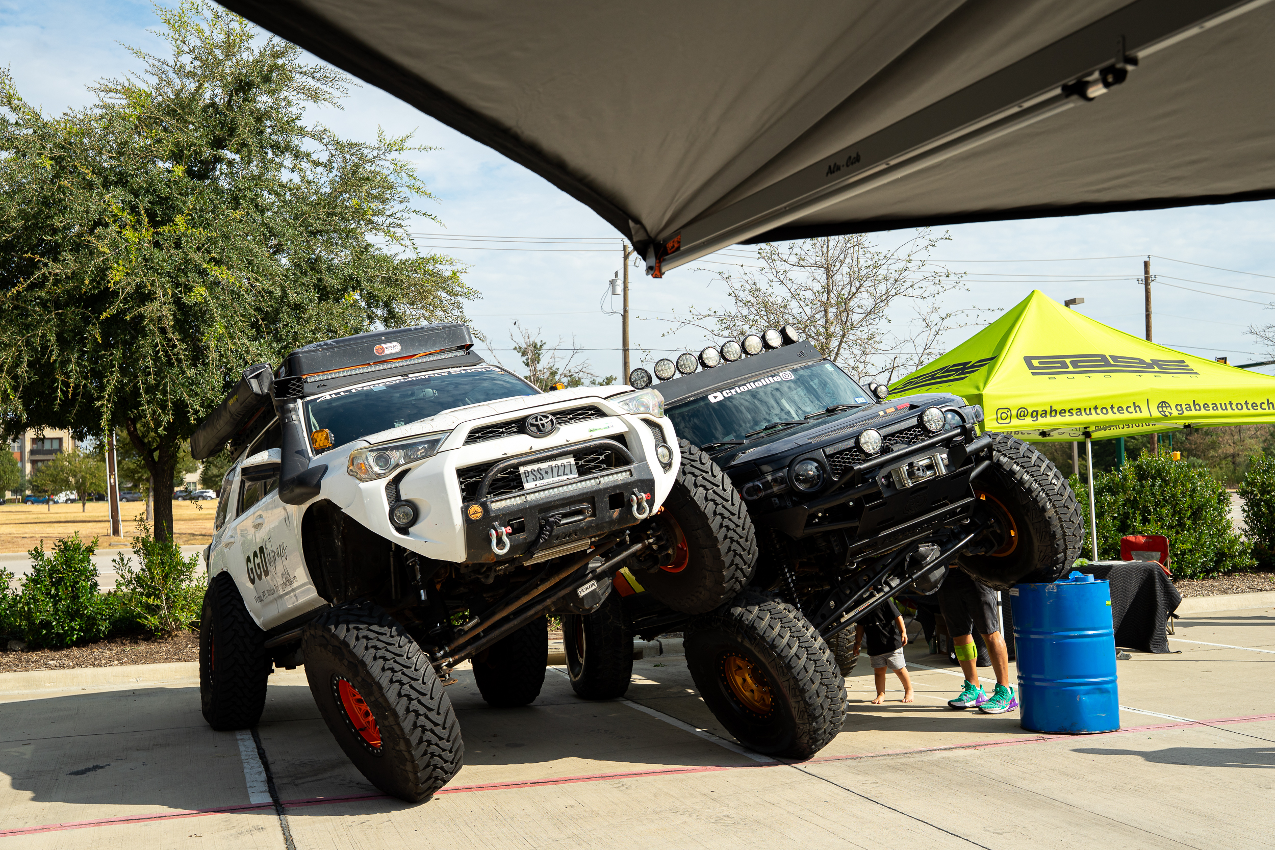 Two 4Runners flexing on the ramps at the Gabe Auto Tech tent