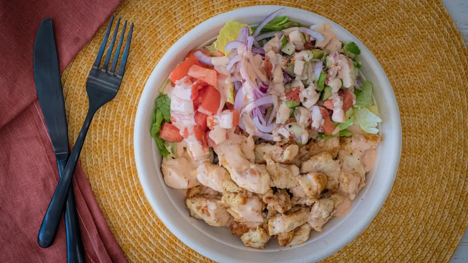 The Pita Bowl: chicken souvlaki over rice with lettuce, tomato, red onion and pita sauce