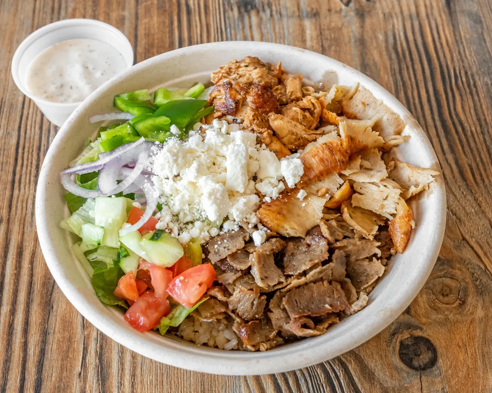 Zeus Bowl with beef and lamb gyro, chicken, feta, green pepper, tomato and cucumber