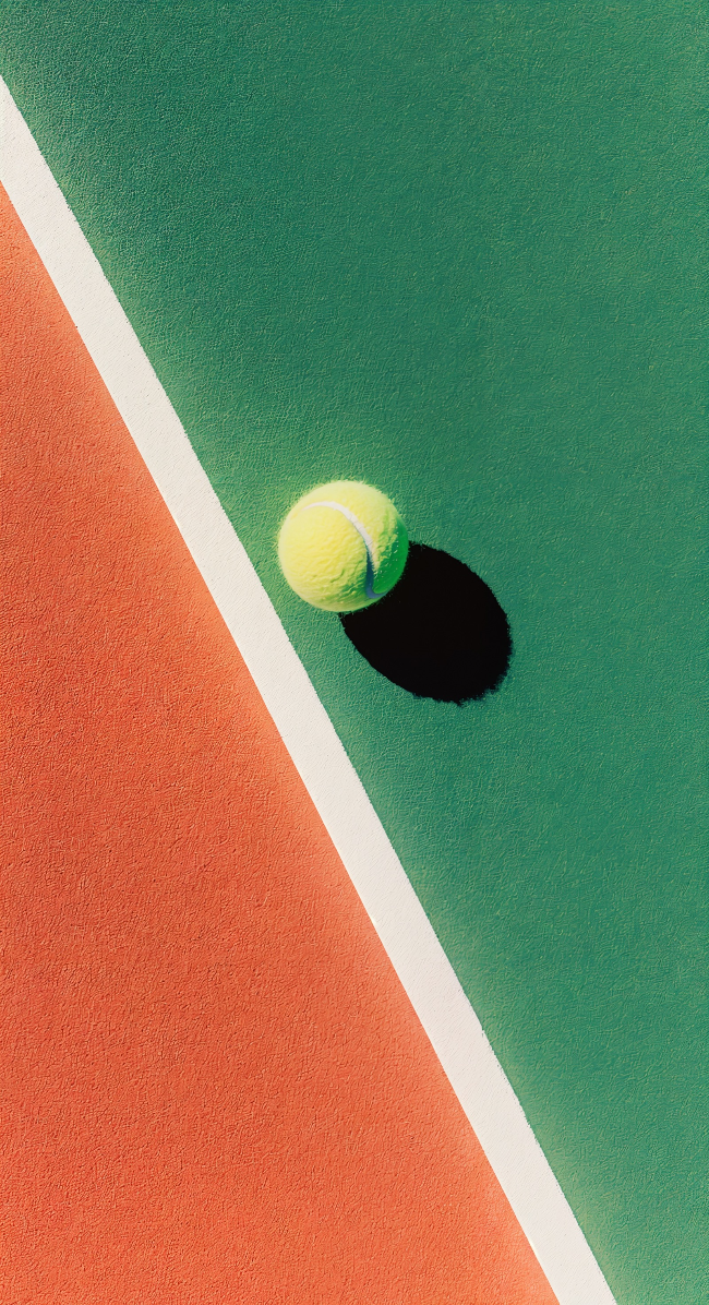 Orange tennis ball on a green tennis court 2