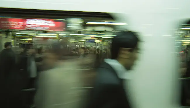 Fast-moving train and people