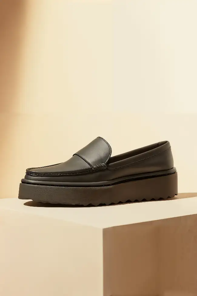 Dark-colored loafer-style shoe