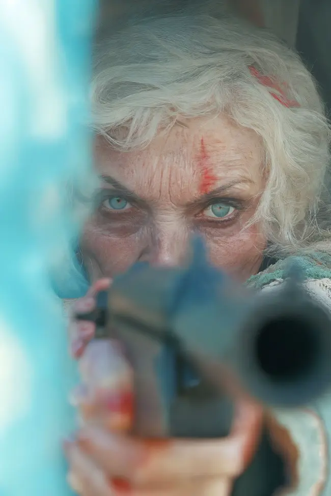 Aged woman holding a gun