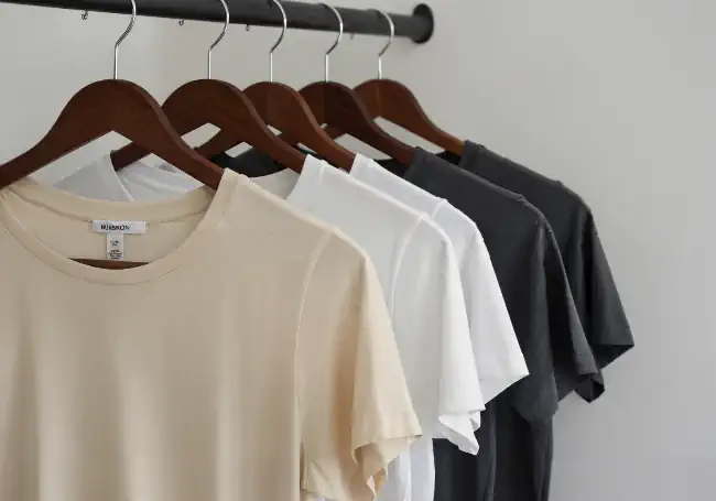 Series of T-shirts lined up on hangers 4