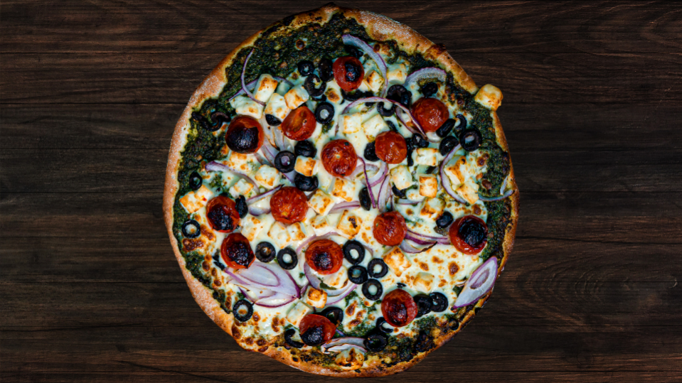 A Grecian pizza with spinach and feta