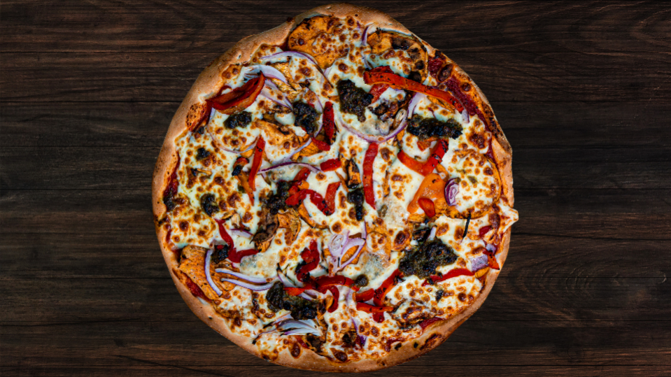 A sweet potato pizza with pesto and blue cheese