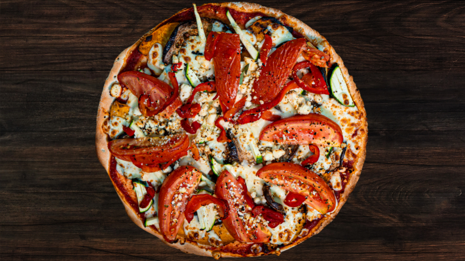 A Vegi Delight pizza with a side of pesto aioli