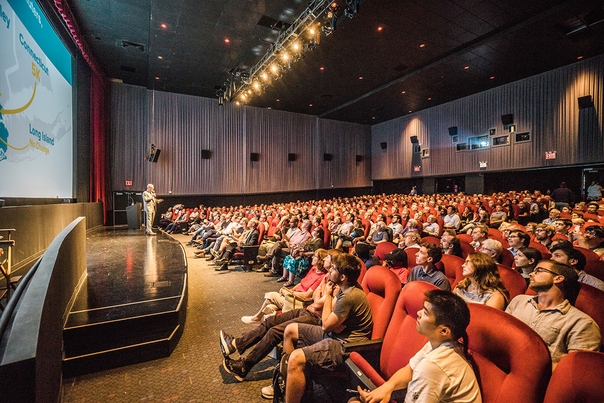 Audience members seated at in the theater for Tom Wright's presentation.