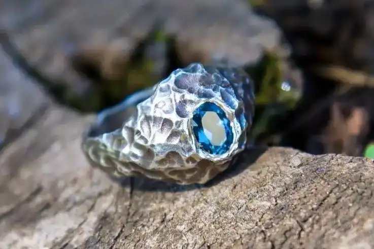 Man sterling silver ring with a blue topaz stone