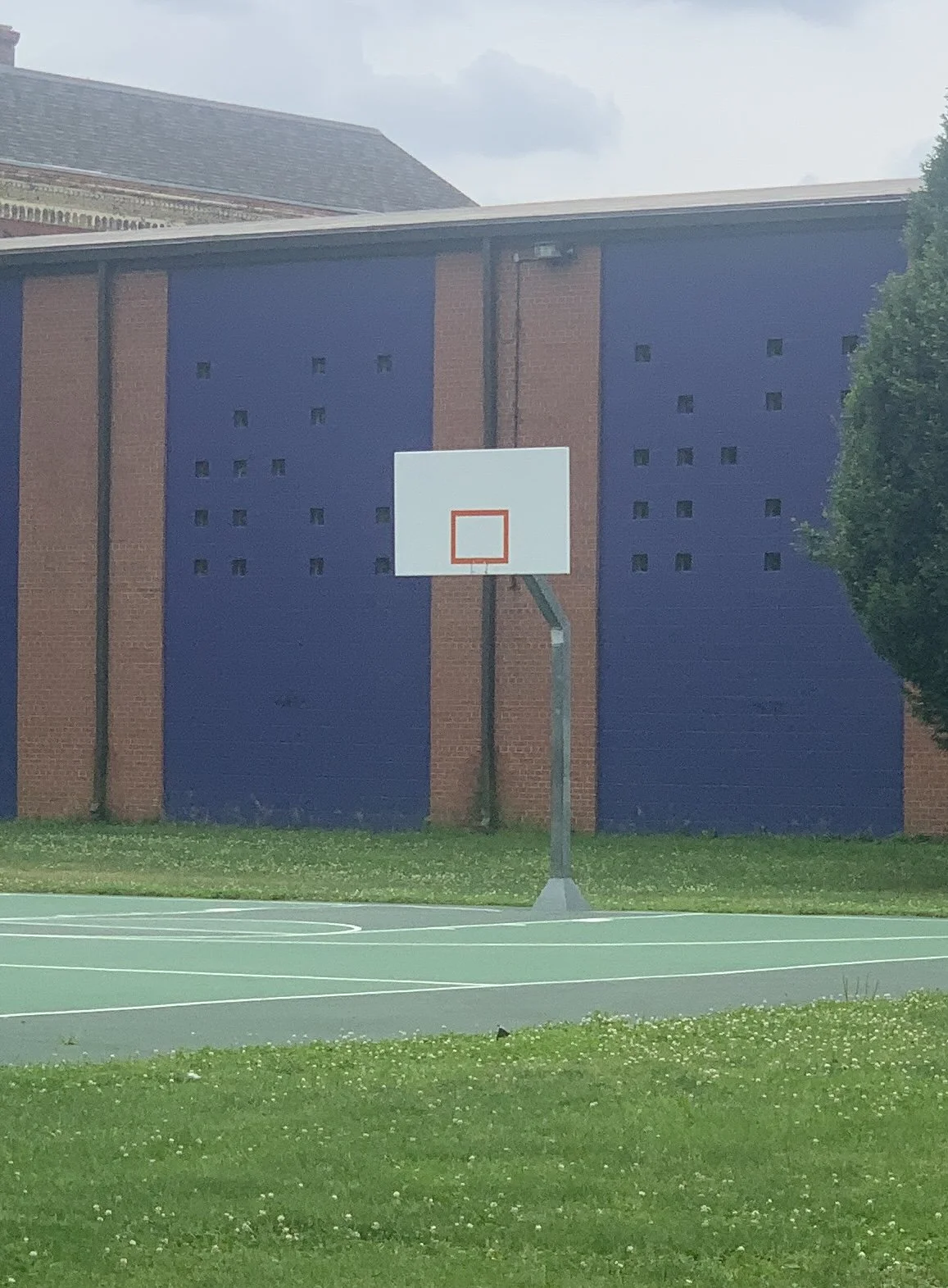 Image taken of a basketball hoop without a rim/net in Columbus, OH during Covid
