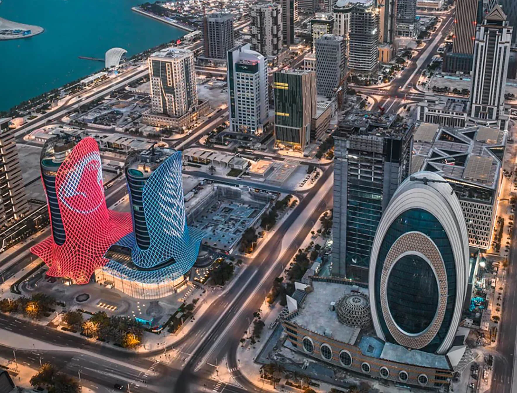 Aerial view of Al Jaber Twin Towers in Doha, featuring the twin high-rise structures and surrounding urban cityscape.