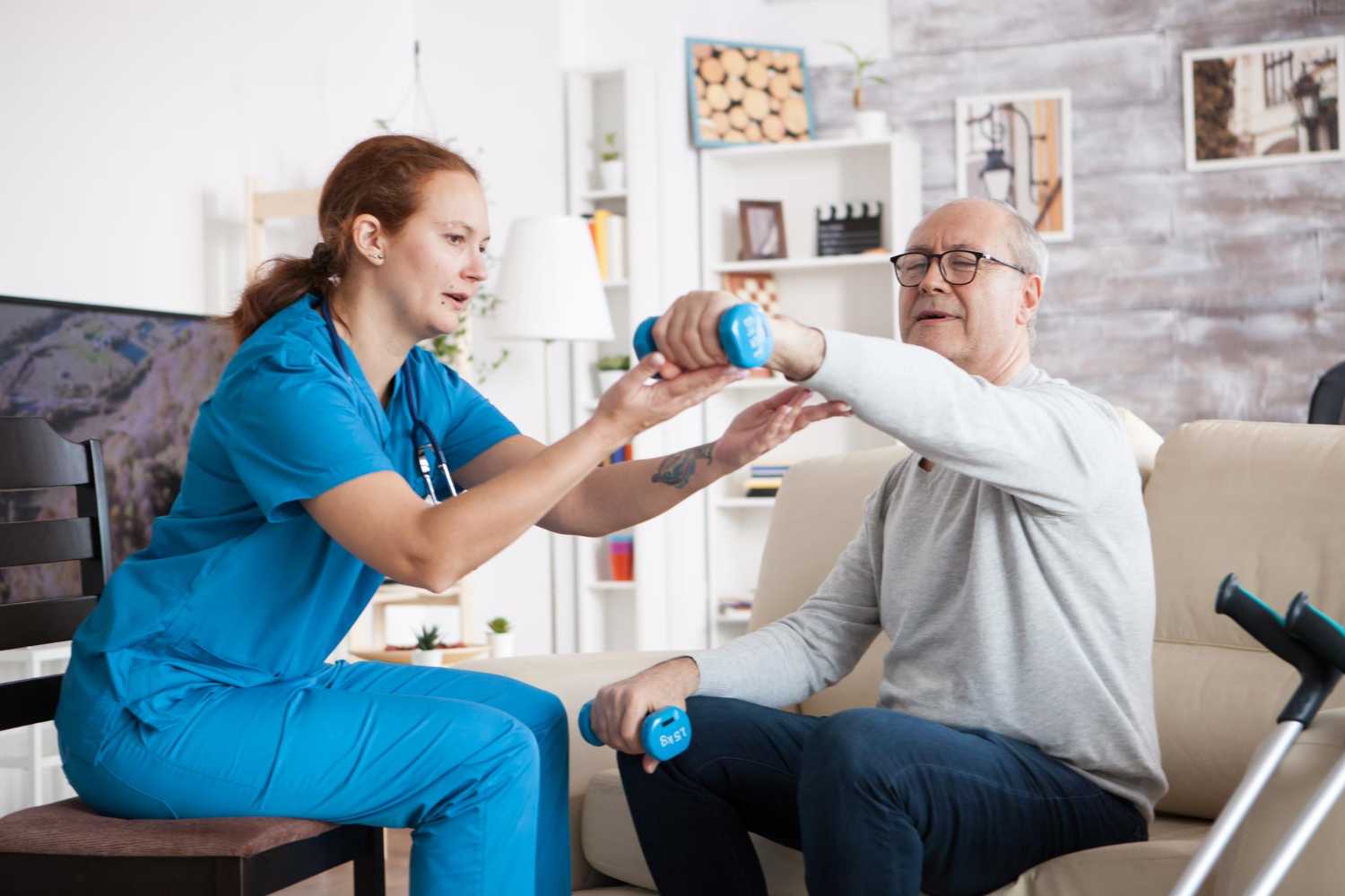 An elderly man doing a light workout at home with guidance from a physiotherapist.