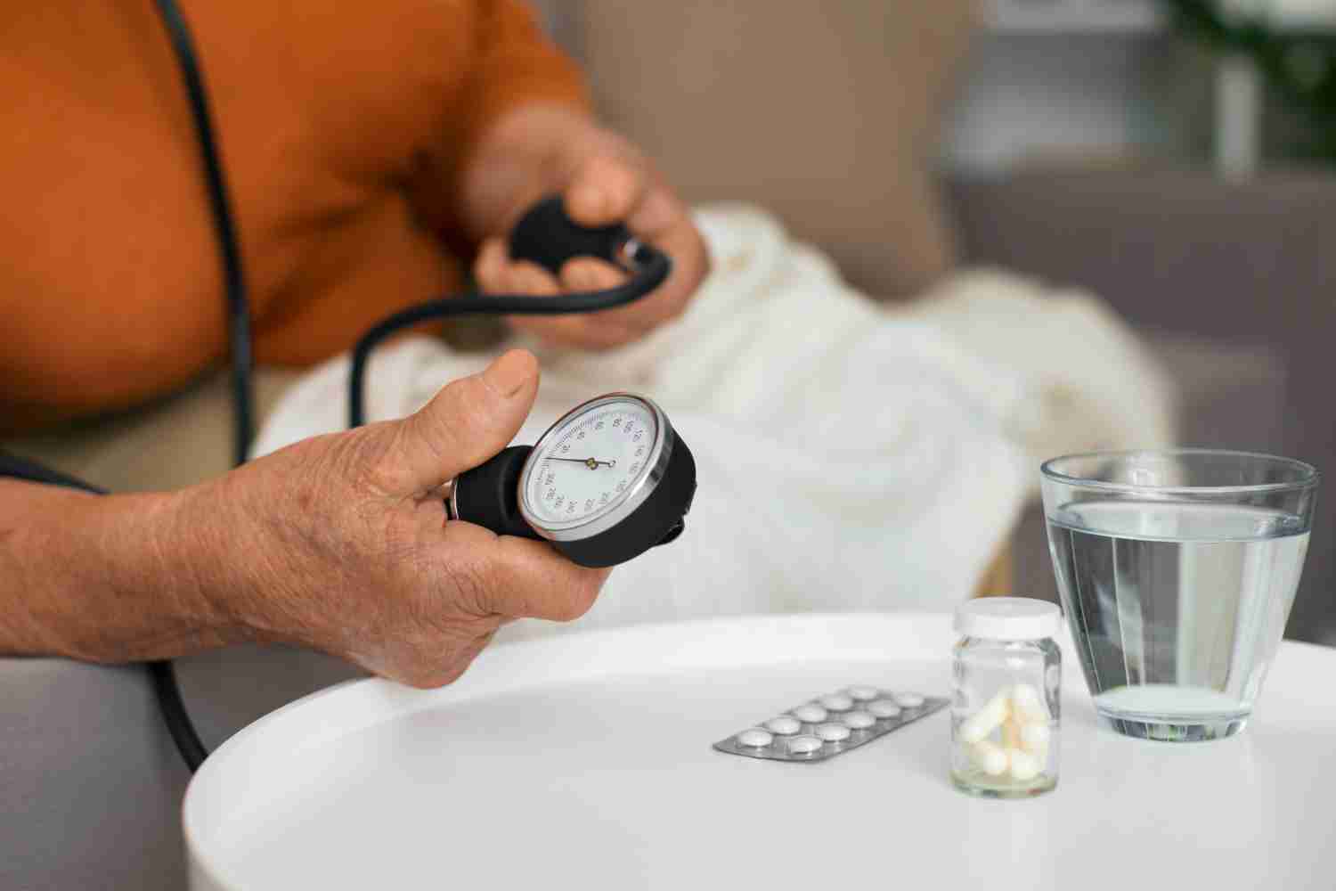 Close-up of a digital blood pressure monitor showing a healthy reading.