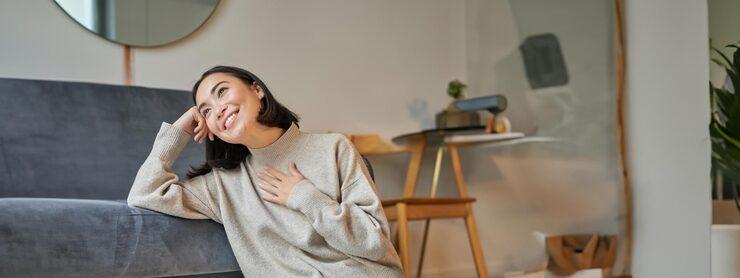 Woman who is smiling sitting on the floor