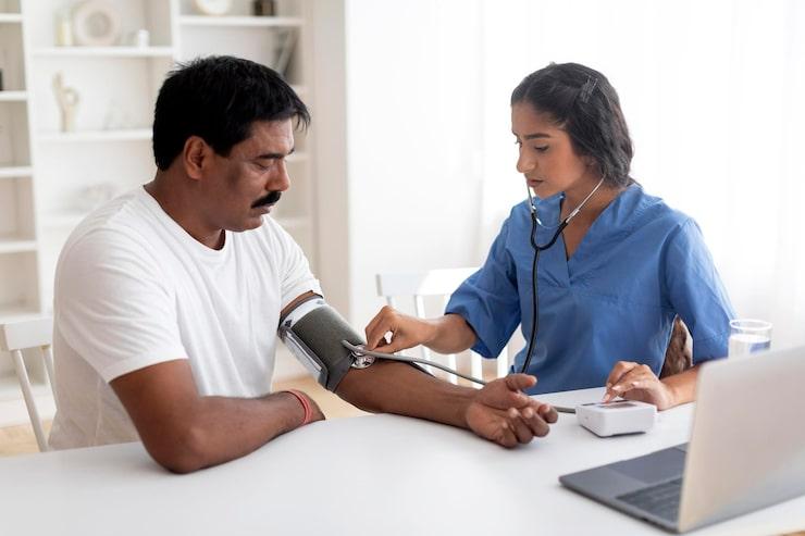 Female doctor checking blood pressure