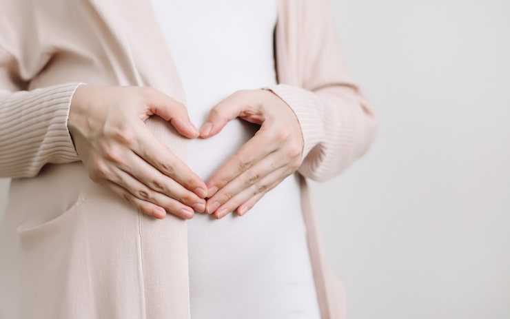 Pregnant woman holding her belly