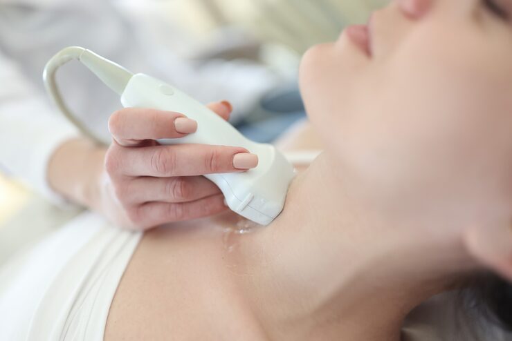 Doctor checking the thyroid of a patient