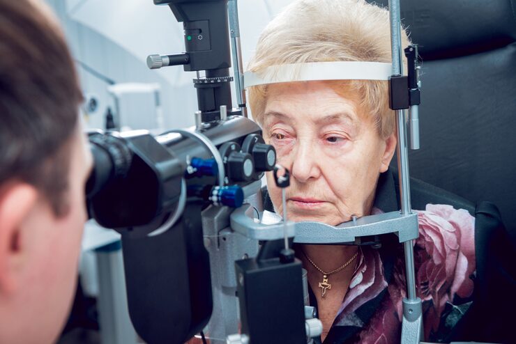 An elderly woman getting her eyes checked by a doctor