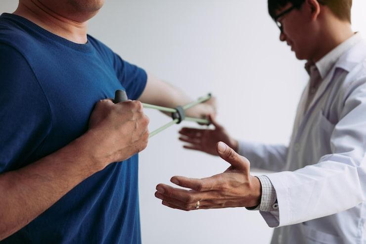 A patient getting help exercising post surgery
