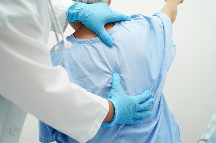 doctor examining a patient’s back