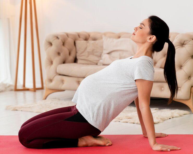Pregnant woman in third trimester stretching