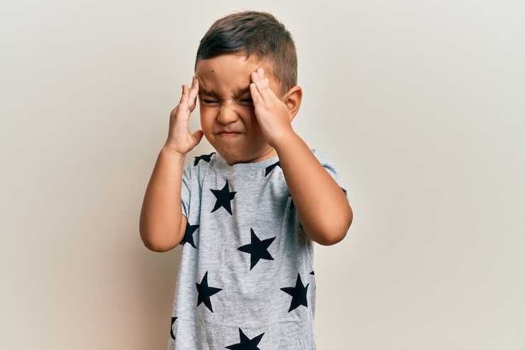 kid suffering from headache