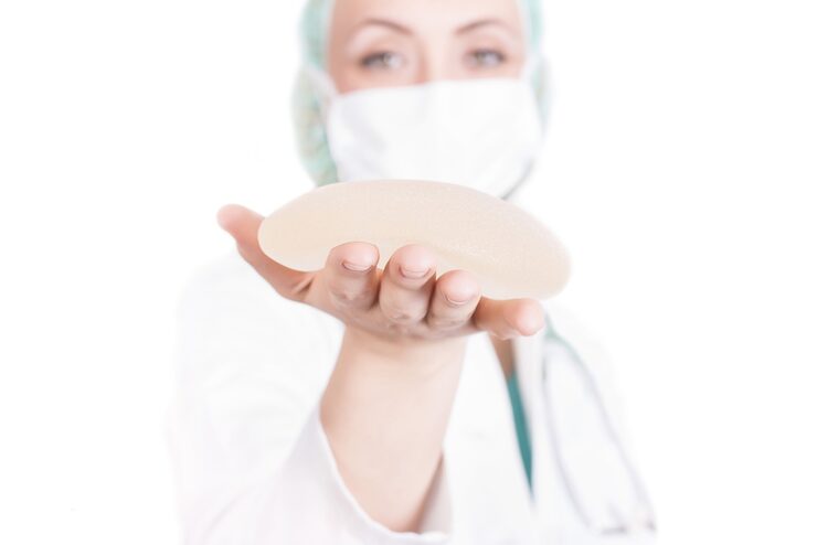 doctor holding a silicone implant