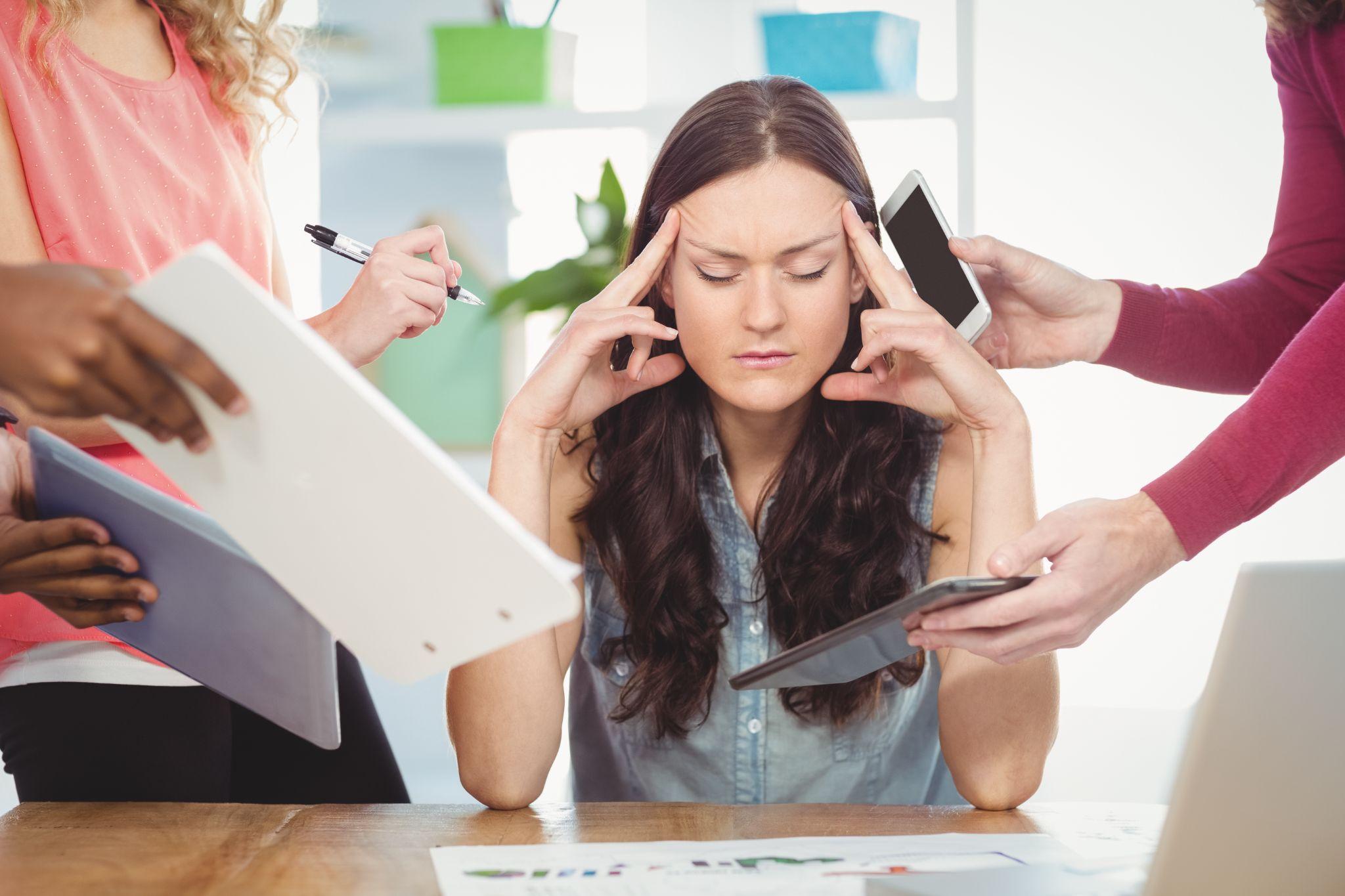 Depressed working business woman with eyes closed.