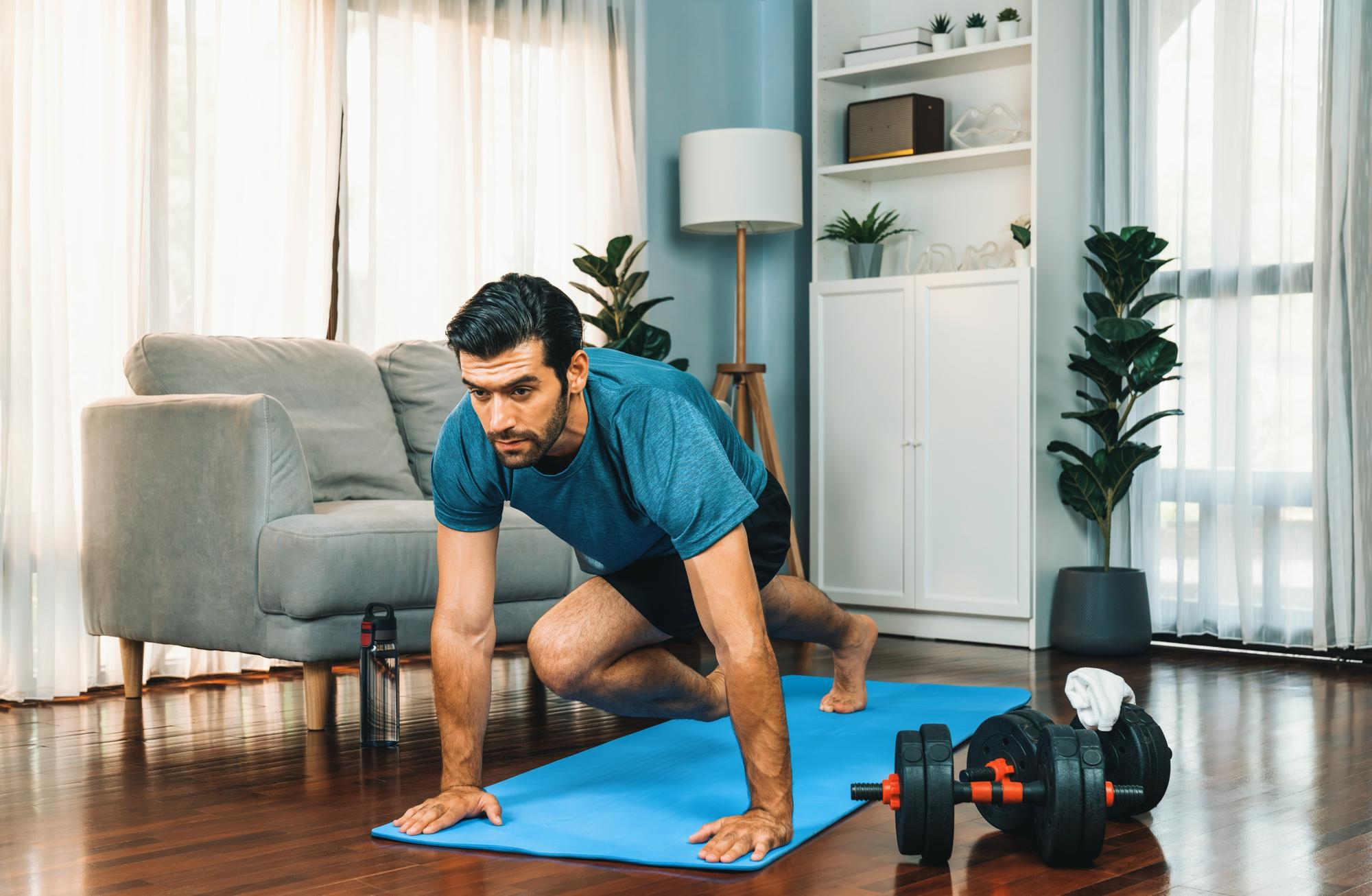 A man exercising at home to maintain heart health and manage blood pressure.