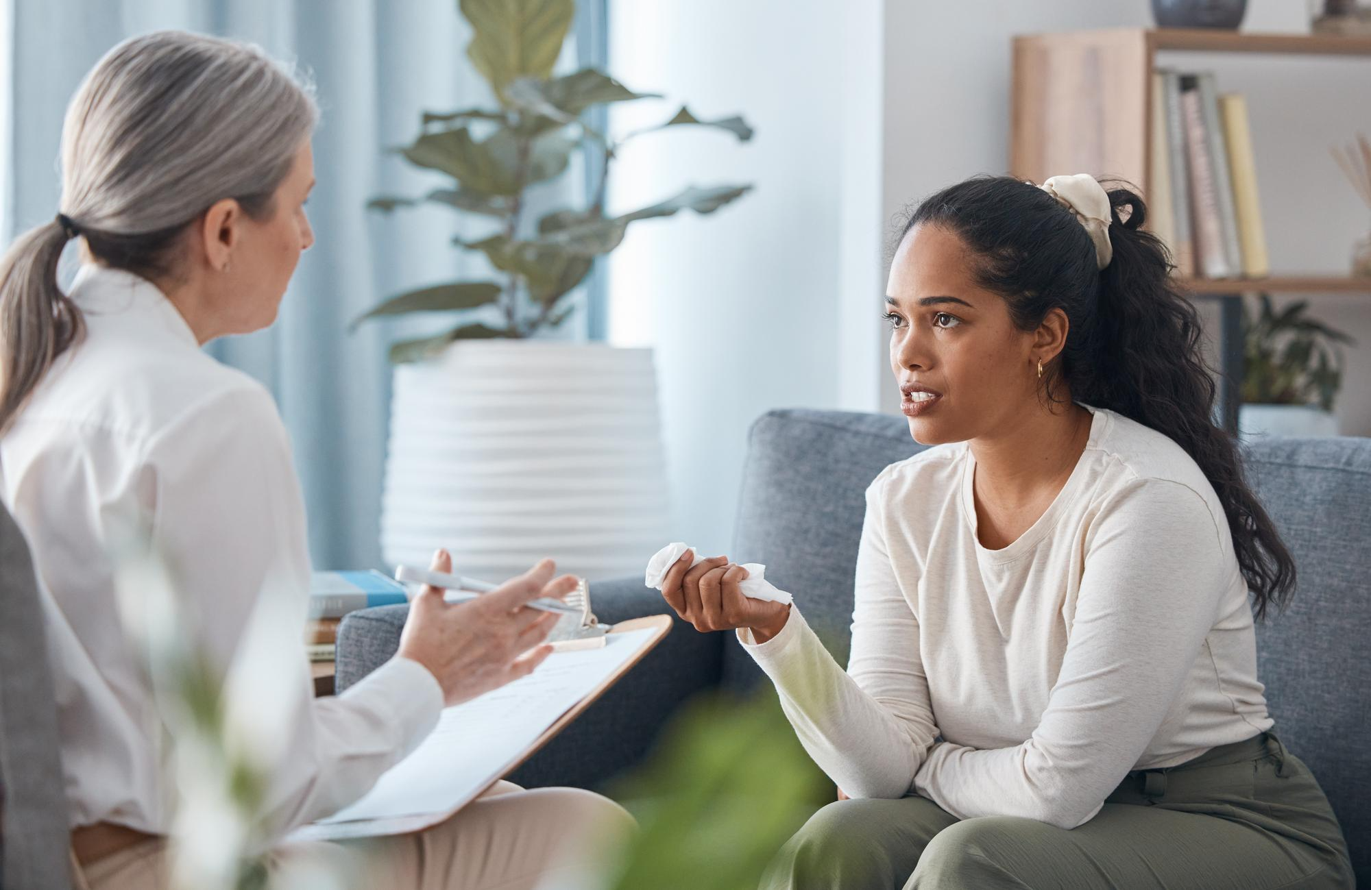 A person in therapy gaining emotional clarity and guidance while talking with a counselor.