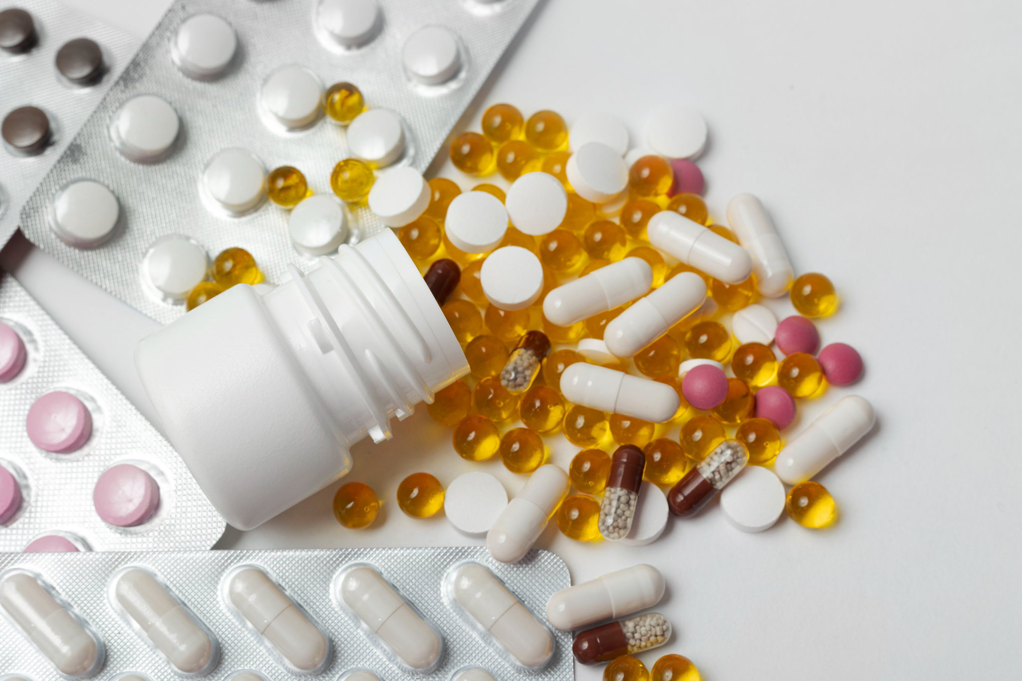 Medications and multivitamin tablets kept together representing supplement use with medicines