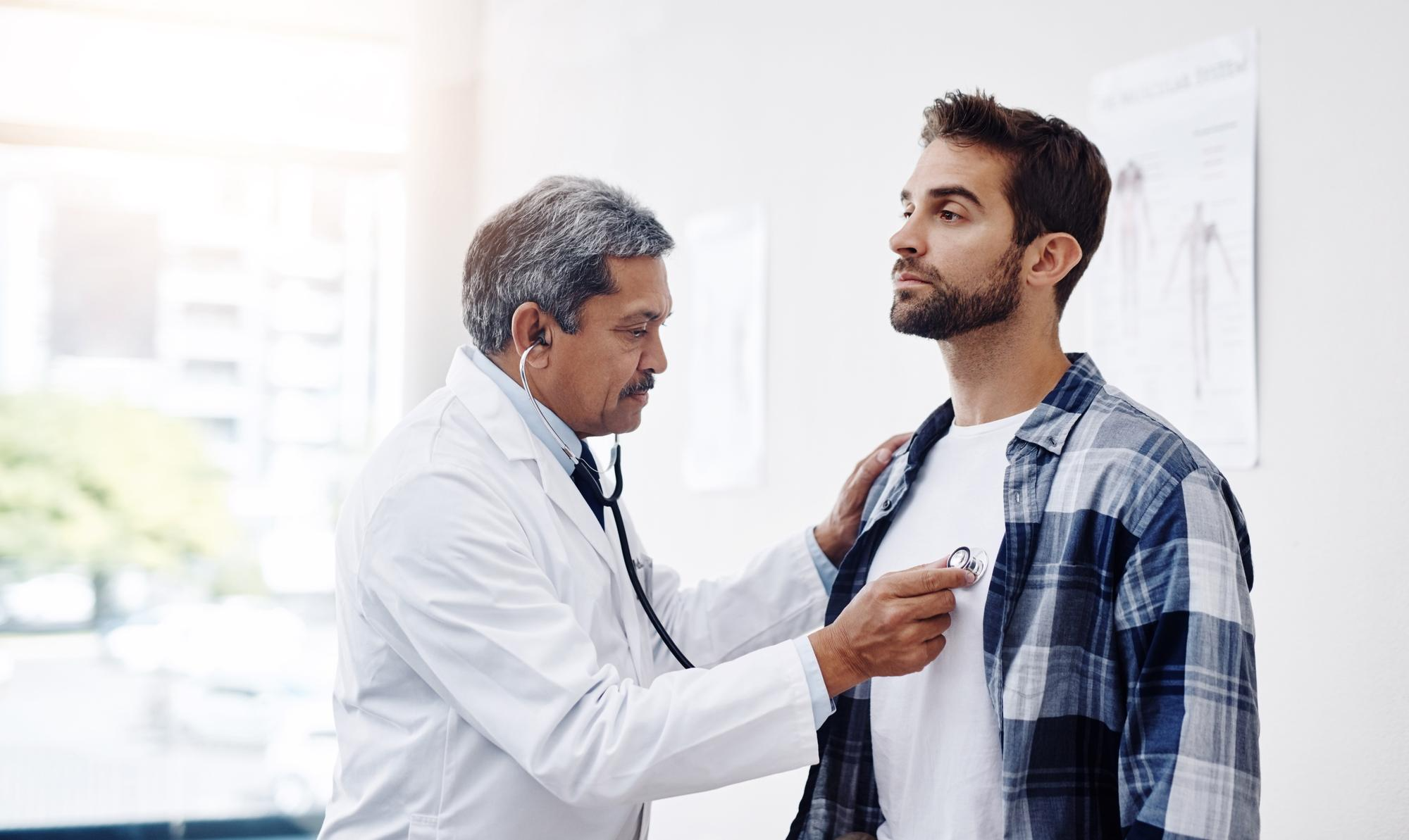 A doctor examines a patient in a clinical setting, using medical tools, gently assessing symptoms.