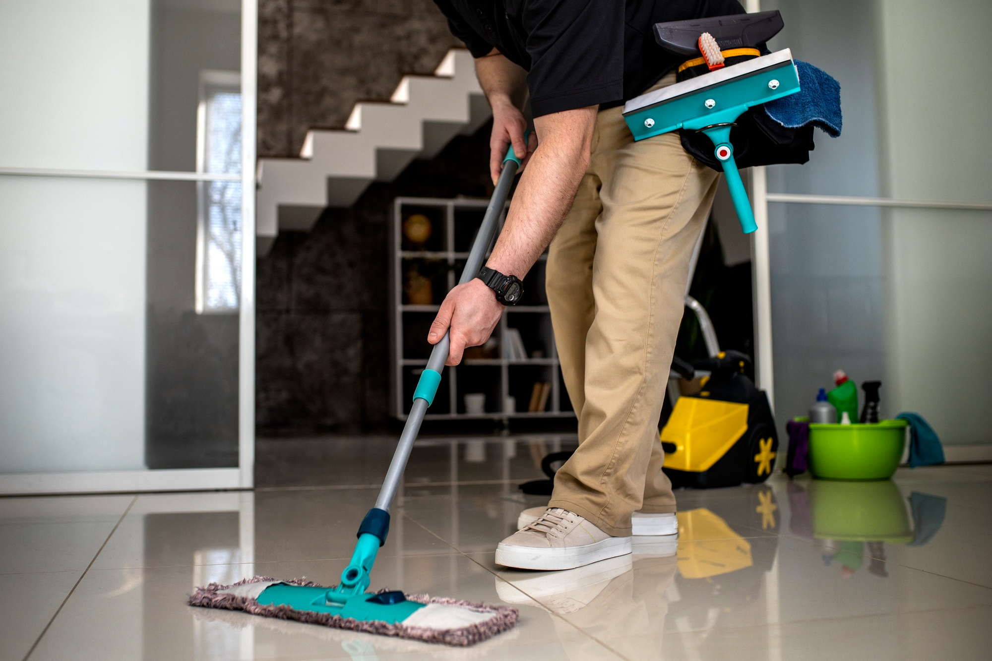 A person cleaning the house using cleaning tools to maintain hygiene and cleanliness.