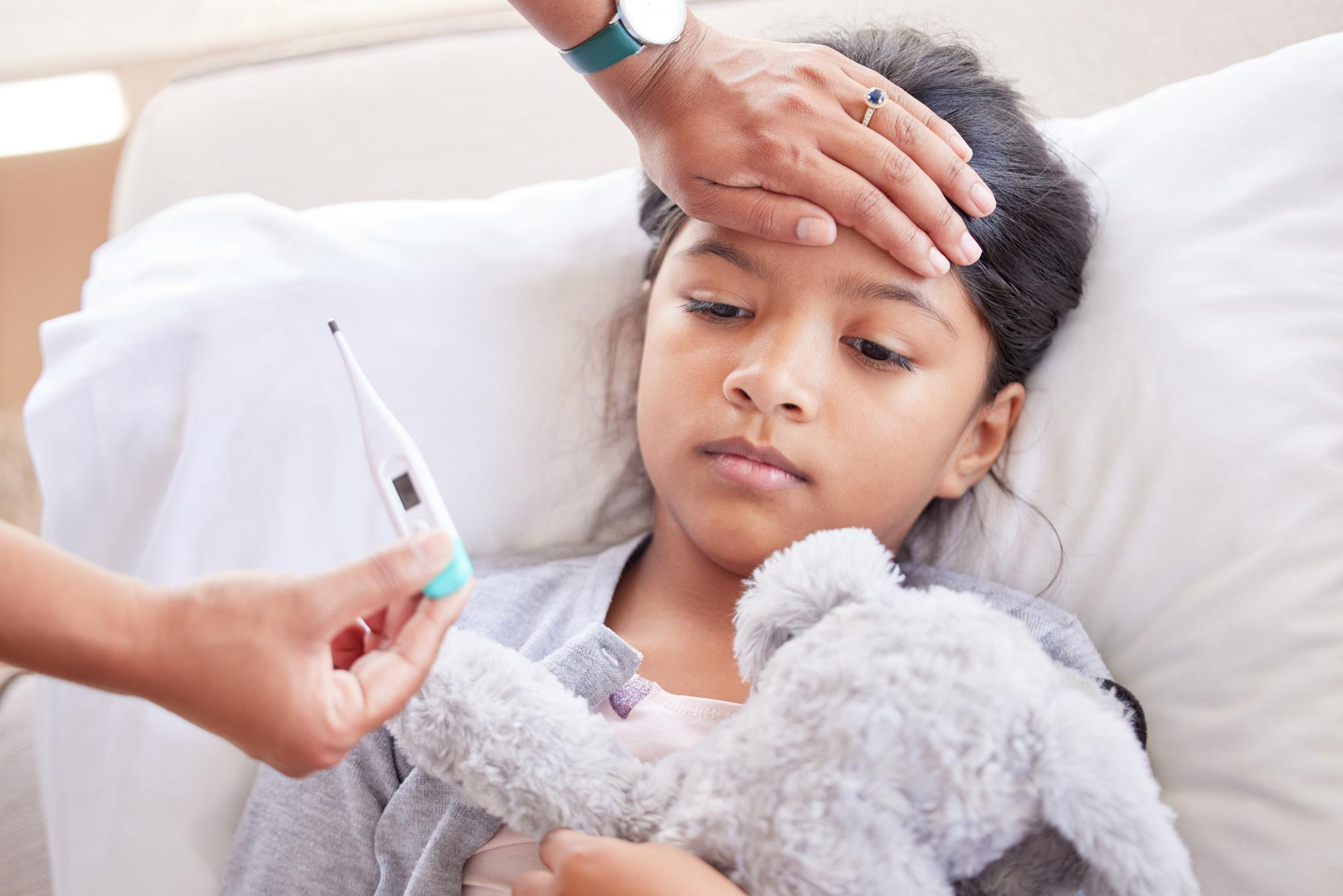 A child appearing unwell with symptoms of fever, highlighting the importance of timely care, monitoring temperature, and proper treatment in children.