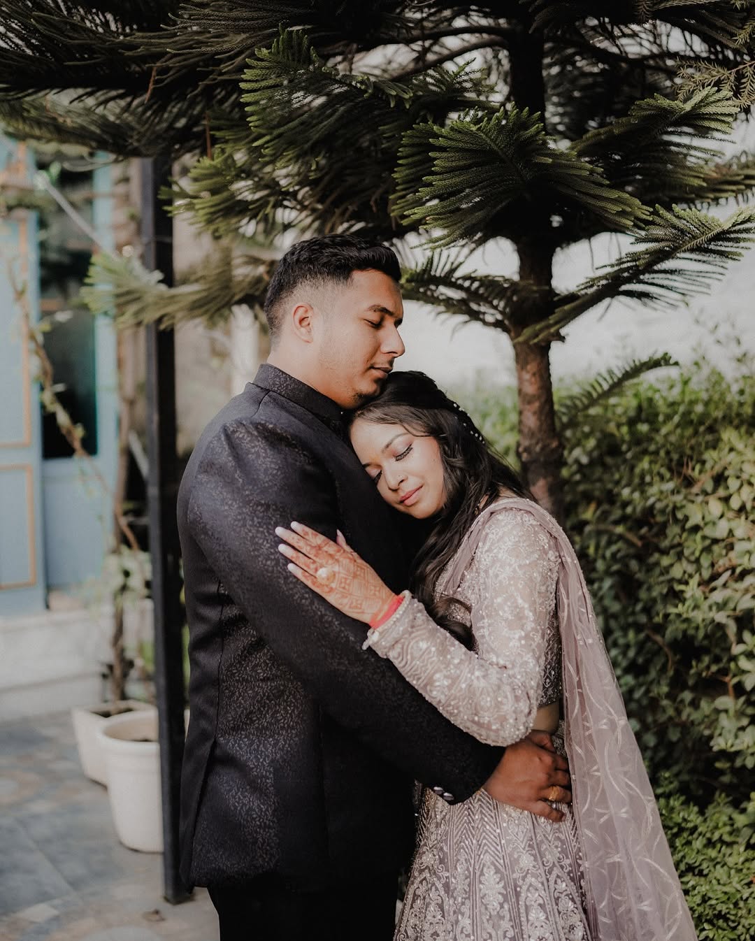 A bride and groom in a tender moment during their wedding.
