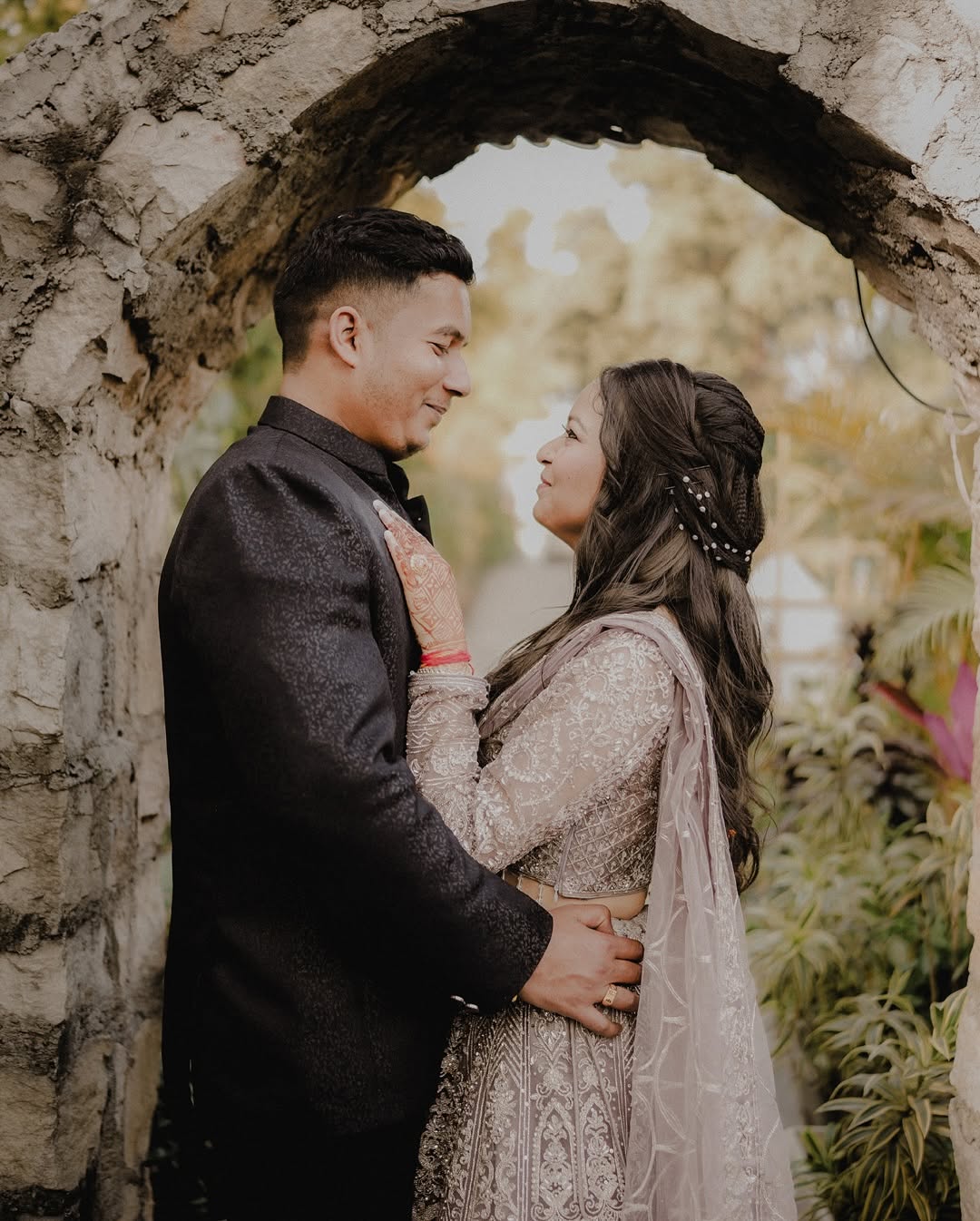 Close-up of the bride and groom holding hands, showing their rings.