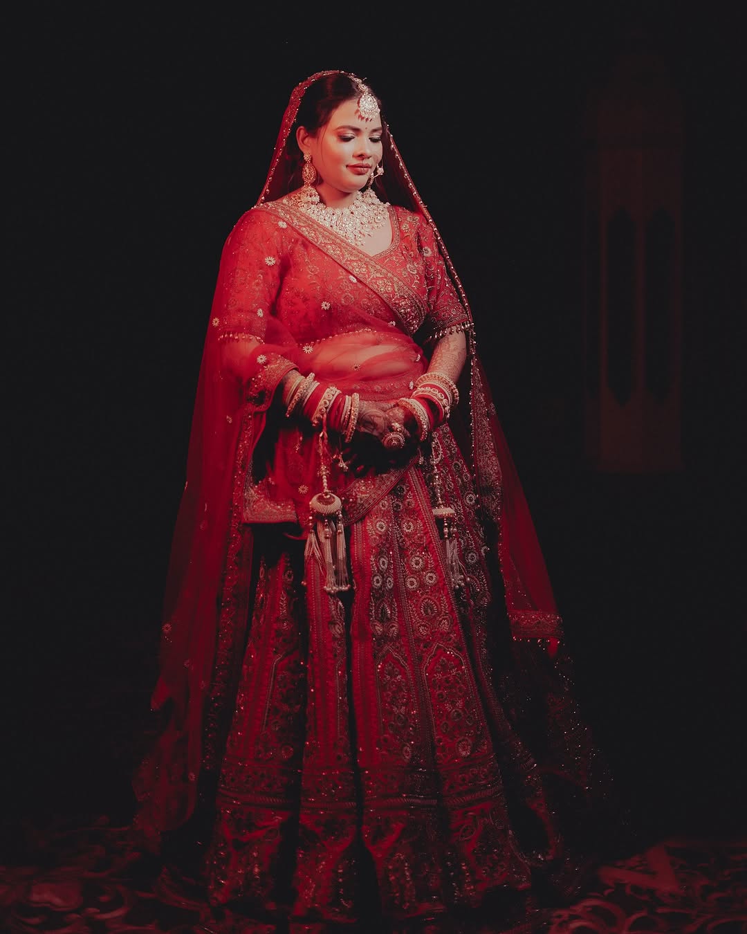 A beautiful bride posing in her traditional wedding attire.