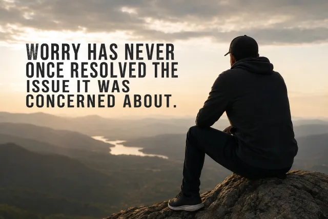 Man sitting on a mountain cliff overlooking a valley, with text quoting that worry never resolves what it worries about.