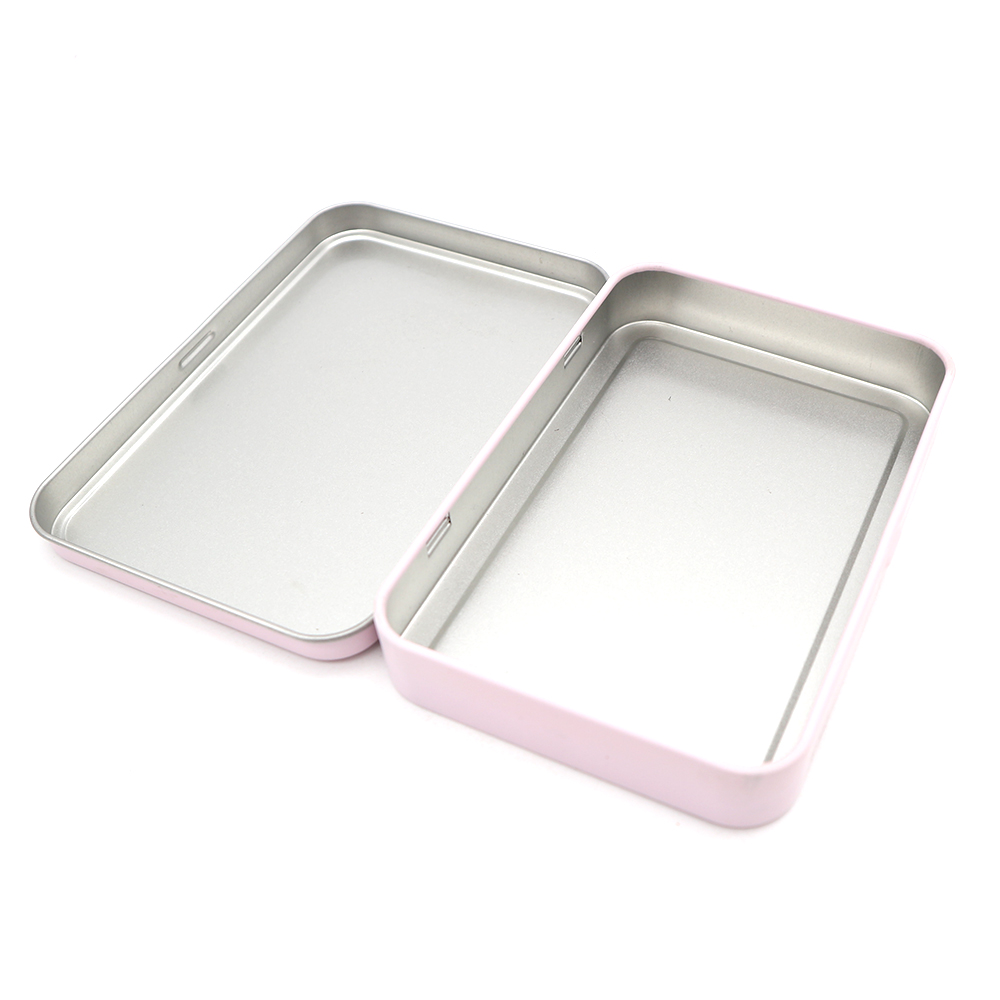 Neatly organized cosmetic brushes stored inside a metal hinge top tin container for convenience.