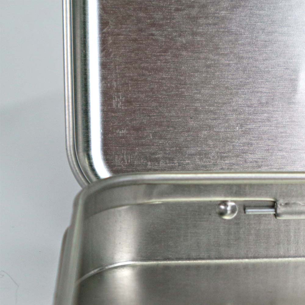 Colorful cosmetic tin box with a hinged lid designed for secure makeup storage and personalized styling options.