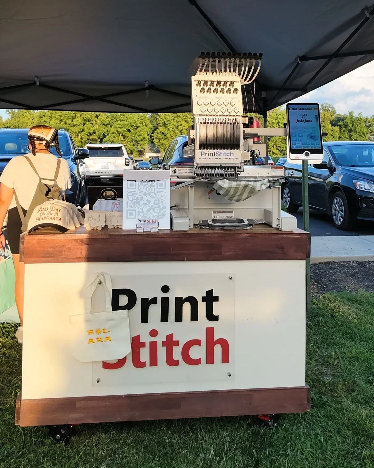 PrintStitch embroidery machine set up under a tent for live embroidery at Spencer Farm Winery