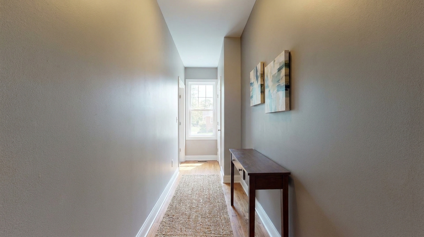 Entryway with two small abstract prints above a slim console table